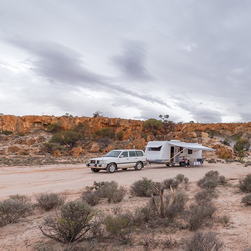 Car pulling caravan outback